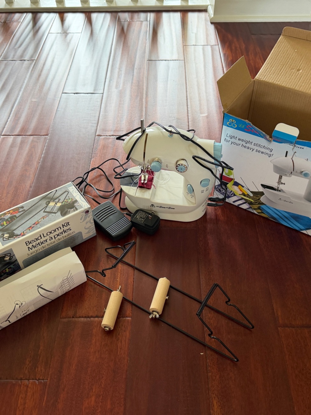 Portable Mini Sewing Machine with Cream Body and Black Accessories